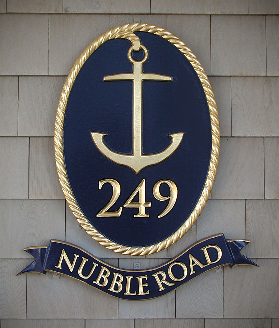 Home sign for Nubble Road in Cape Neddick featuring a carved anchor, ribbon and carved rope border