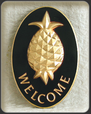 carved pineapple sign with gold leaf