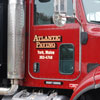 A large dump truck lettered with reflectiv gold vinyl and black shadow