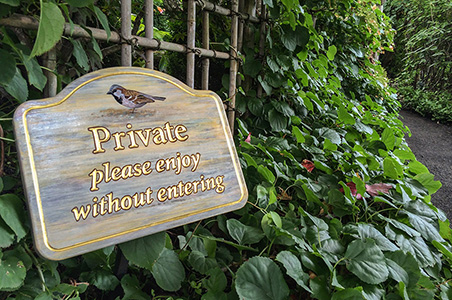private-please enjoy without entering sign for a private garden near a public path